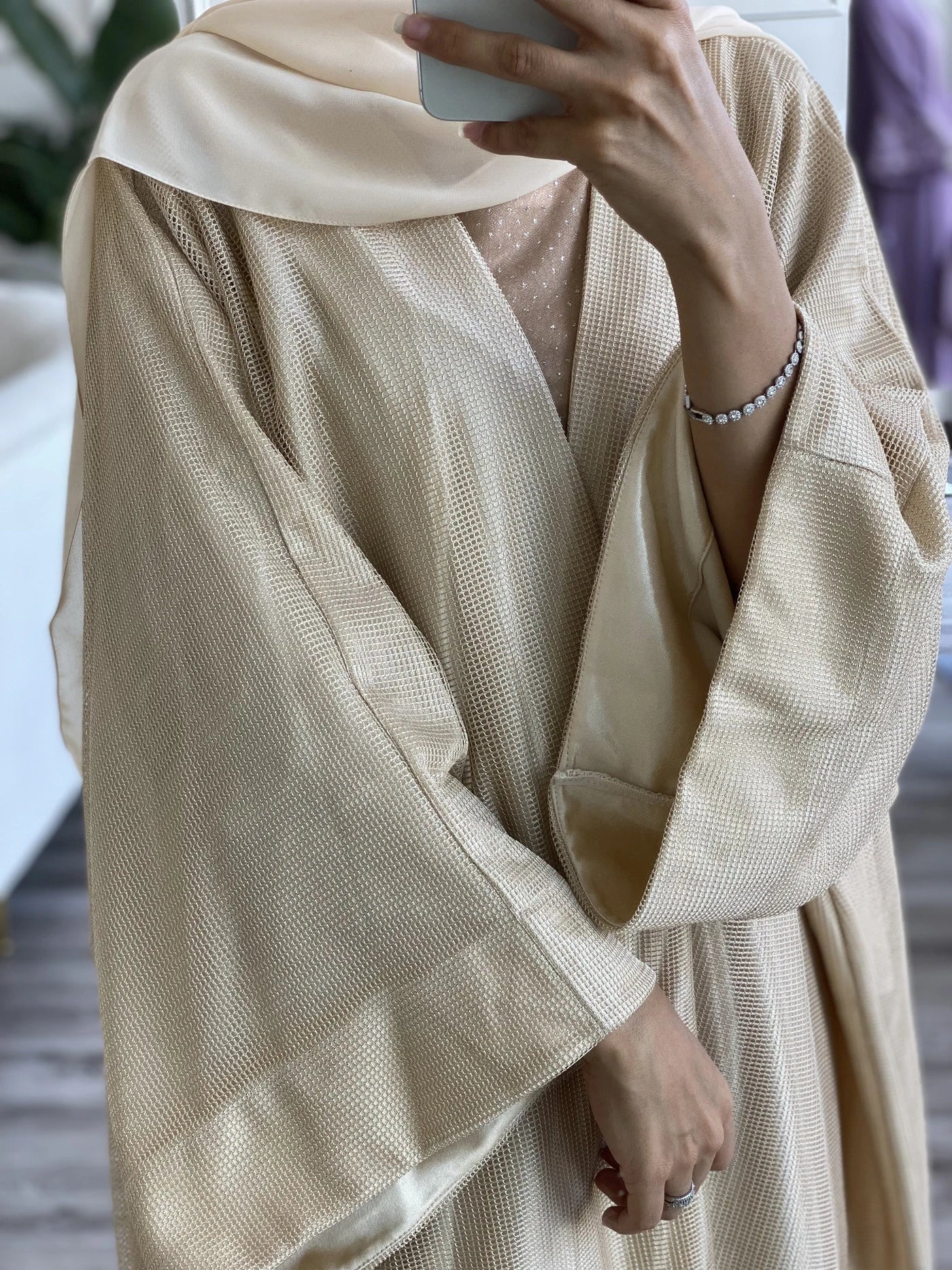 Elegant beige abaya with underdress featuring flowing sleeves and textured fabric for stylish modest wear
