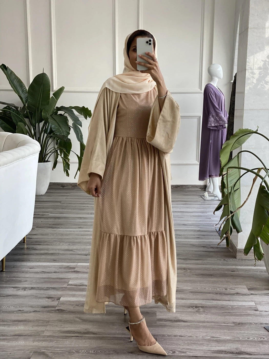 Elegant beige abaya with underdress featuring flowing sleeves and tiered design for stylish modest wear