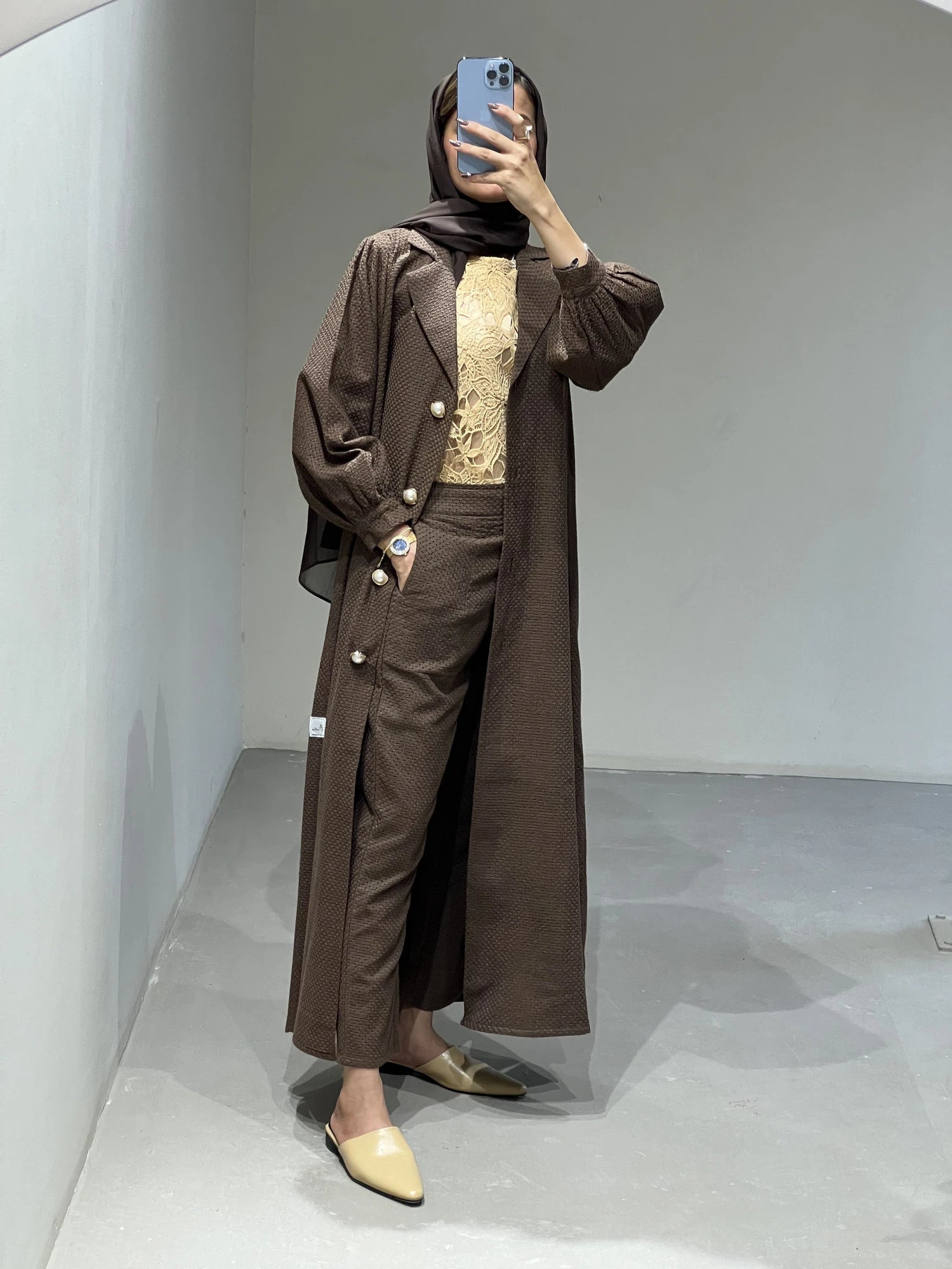 Elegant brown luxury abaya set Dubai featuring a long coat and matching pants, styled with a chic top